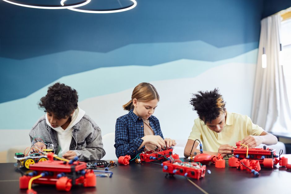 Children working on robotics projects in a classroom setting, learning and engaging.