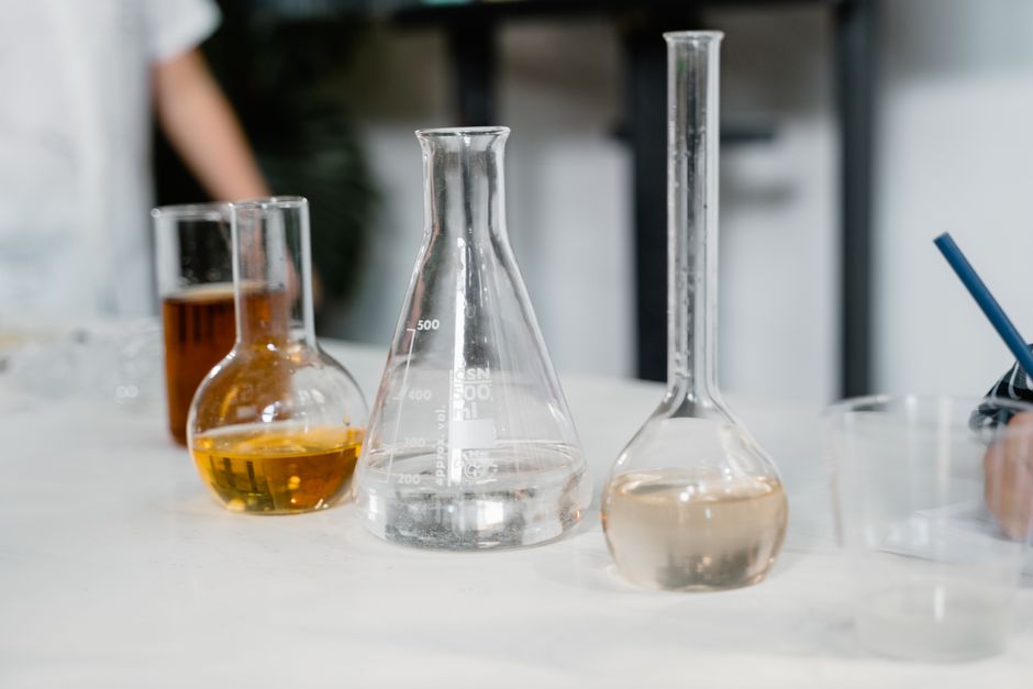 Laboratory glassware including beakers and flasks on a table during an experiment.